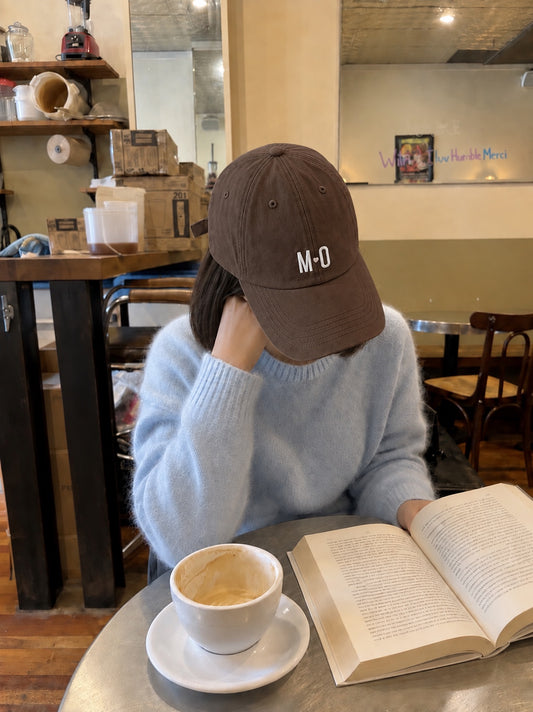 MO Everyday Cap walnut coffee and book lifestyle